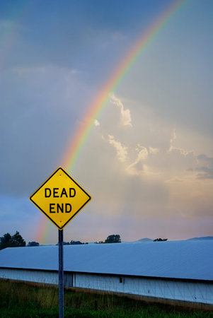 Cloudy sky with beautiful rainbow behind a 
