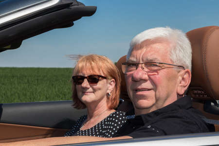 Senior couple in sports carの写真素材