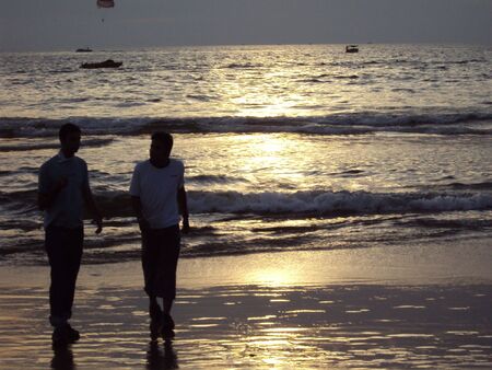 Friends along the Calangute Beach in Goa, India at Sunsetの写真素材