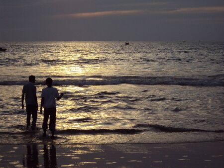 Friends along the Calangute Beach in Goa, India at Sunsetの写真素材