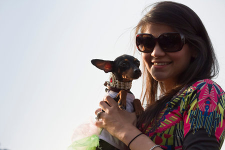 A Girl carrying Chihuahua Dog at PetFed 2015 in New Delhi, India.のeditorial素材