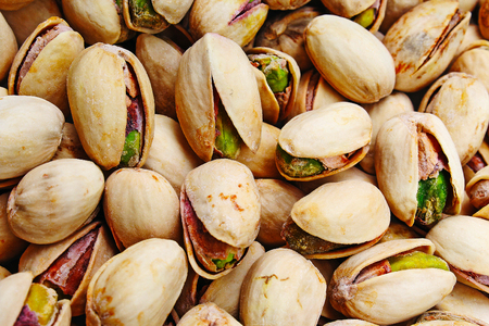 Pistachio texture. Nuts. Green fresh pistachios as texture. Roasted salted pistachio nuts healthy delicious food studio photo.の写真素材