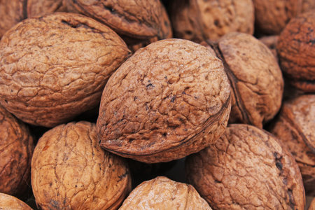 Walnut texture. Brown big walnuts as background. walnut nuts pattern close up photo.