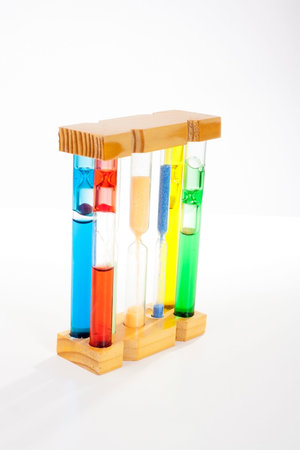 Sandglass photo. Colorfull sandglasses. Sandglass on isolated white studio background.