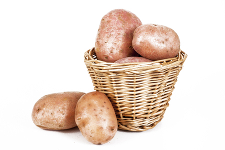 Potato potatoes on basket On isolated white studio background. Clipping path. Single object on white background.の写真素材