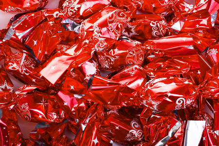 Christmas candy european christmas tree ornaments jelly sugar with chocolate in shiny red foil.の写真素材