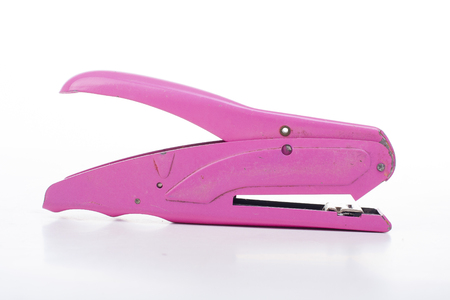 Stapler pink old stapler tool on isolated white studio background.の写真素材