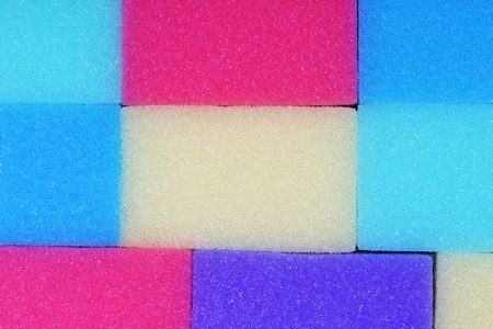 Cleaning kitchen sponge texture as background. Colorful yellow pink green purple blue multicolor sponges. Close up macro about sponges. Sponge pattern textures concept background or wallpaperの写真素材