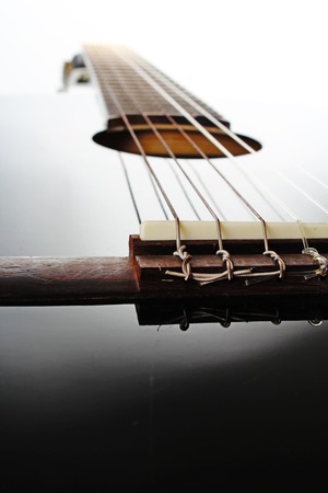Guitar string closeup. POV artsy black shiny reflective guitar studio photo.の写真素材