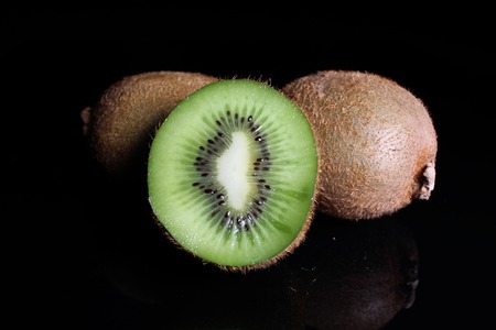 Kiwi kiwis and half kiwi on black background. Studio photo.の写真素材