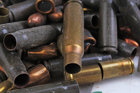 Heap of gun bullets. Weapon Cartridge case sleeve background texture, 7.65, and 9mm. Weapon...