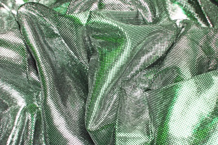 Silver silk design background. Silky fabric cloth designer dress material as texture background. Pattern closeup..の写真素材