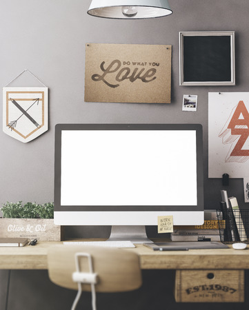 Stylish workspace with computer and posters on home or studioの写真素材