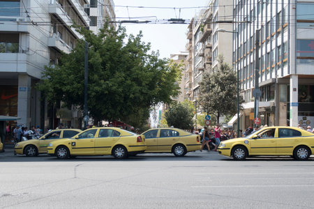 Athens, Greece - August 06 2016: Yellow taxis on Syntagma square. About 14.000 taxis are in operation in Athens.のeditorial素材