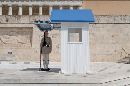 Athens, Greece - August 06 2016: A presidential guard at Greek Parliament square. Eyzones are members of the Greek Army with traditional uniforms and guard in pairs the Tomb of The Unknown Soldier.のeditorial素材