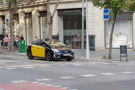 Barcelona, Spain - 25 September 2016: Hybrid taxi at a taxi stop in Barcelona. Yellow and black taxi car parked in Barcelona City center.のeditorial素材