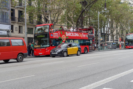 Barcelona, Spain - 24 September 2016: Hop On Hop Off tourist bus at Barcelona. Double decker open air sightseeing coach bus opposite La Pedrera Casa Mila.のeditorial素材