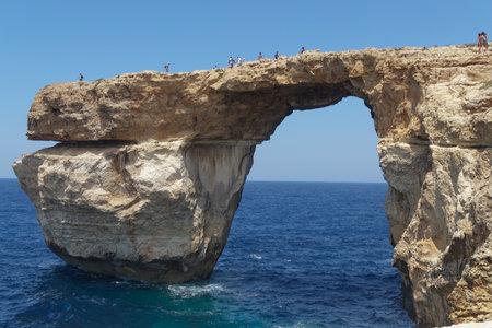 Gozo Island, Malta Azure window tourists on the cliff. Azureus window was in danger of collapsing. It finally collapsed on March 08 2017 after being hit by heavy storms.のeditorial素材