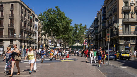 Barcelona, Spain Juan Miro mosaic with crowd on La Rambla area. Cirqular mosaic on the pedestrian...