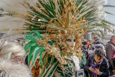 Venice, Italy carnival mask and costume pose in Saint Mark square.Masked person in traditional costume poses at a Venetian square during the Venice 2019 Carnival.のeditorial素材