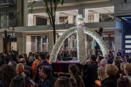 Good Friday Orthodox Easter Epitaph procession in Thessaloniki, Greece. Crowd attends the Epitaph commemoration of decorated with flowers Epitafios at night in the city center streets.のeditorial素材