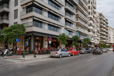 Thessaloniki, Greece people enjoy coffee at city center cafe bars. Unidentified crowd drinking frape or other beverage at outdoors seating bars in Nikis Avenue before the waterfront.のeditorial素材