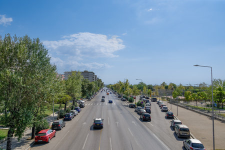 Thessaloniki, Greece city road traffic on a multi lanes avenue. Elevated day sunny view of Leoforos Megalou Alexandrou with passing cars.のeditorial素材