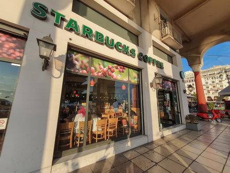 Starbucks Coffee Store facade. External evening view of famous coffeehouse chain store in Aristotelous square Thessaloniki, Greece.のeditorial素材