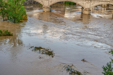 Rome, Italy Tiber river high tide water rise. Day view of high water level flooding the banks of the...