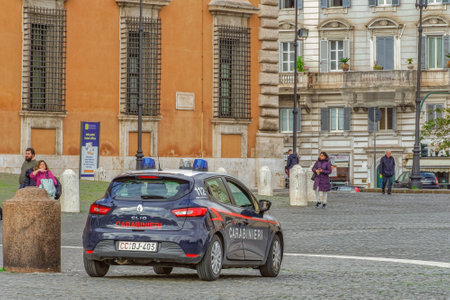 Rome, Italy Carabinieri Italian Police car patrolling. Italian military force dark blue vehicle with white roof and red stripe on side, ensuring safety on the Roman capital.のeditorial素材