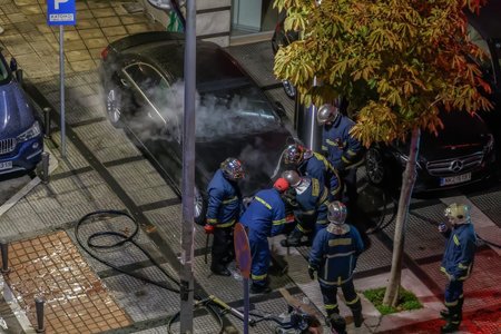 Thessaloniki, Greece Greek firefighters during fire at luxury car showroom. Elevated view of...