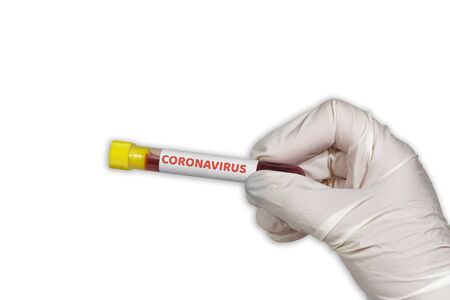 COVID-19 world outbreak concept with coronavirus tag on vacutainer. Female chemist with protective gloves displays blood tube with virus sample against white background.の写真素材