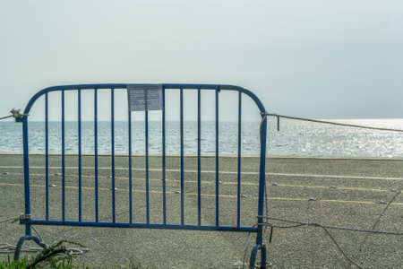 Thessaloniki, Greece - March 31 2020: Ban on waterfront access for coronavirus protection measures. Government forbids walking on the pedestrianized seafront installing railing steal fence with ropes.のeditorial素材