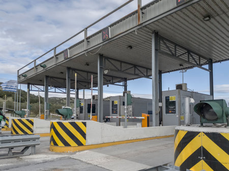 Analipsi, Greece Empty highway toll stations with fee collecting booths. Greek roadway where car drivers need to pay tolls to pass gates for Egnatia Motorway sections access.のeditorial素材