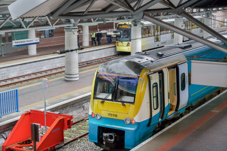 Manchester, UK airport train and metro station. Transpennine Express & Metrolink coach at MAN...