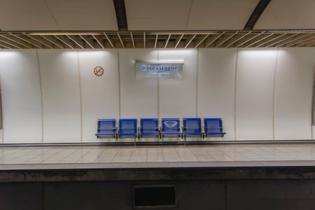 Athens, Greece empty metro Syntagma station. Waiting blue seats without passengers on track platform of Attiko Metro train coaches.のeditorial素材