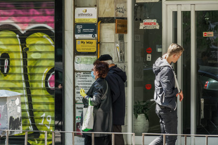 Thessaloniki, Greece Coronavirus measures affect business & daily life. Greeks with mask & gloves...