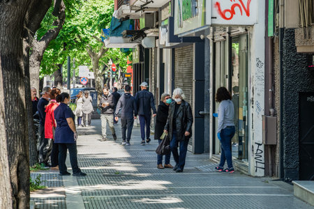 Thessaloniki, Greece Coronavirus measures affect business & daily life. Greeks with masks keep their...