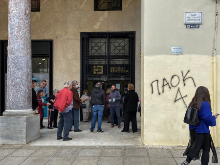 Thessaloniki, Greece Coronavirus measures affect business & daily life. Greeks keep their distance outside bank entrance, in line with government decision to prevent COVID-19.のeditorial素材