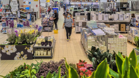 Thessaloniki, Greece - October 20 2010: People with covid-19 masks shop in super market. Unidentified crowd with face protection inside Praktiker DIY home improvement store area.のeditorial素材