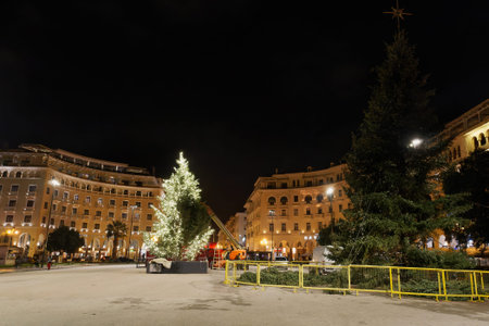 Thessaloniki, Greece - December 6 2020: Decorating Christmas tree at Aristotelous square. Night view of festive instalments at the southern part of main city square.のeditorial素材