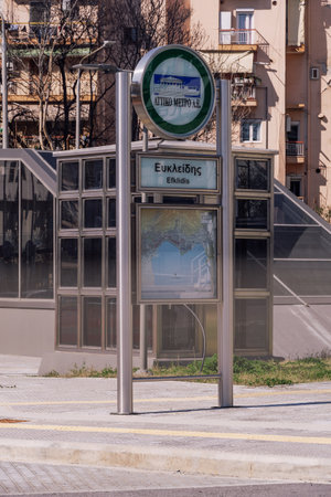 Thessaloniki, Greece - March 27 2021: metro station with map, logo sign and Efklidis stop name. Day view of finished entrance of not yet functional underground line, scheduled to open in 2023.のeditorial素材
