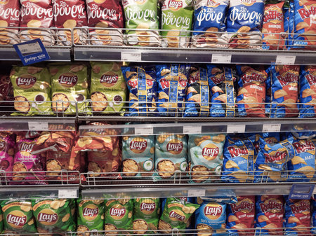 Thessaloniki, Greece - May 5 2021: Various chips brands on sale inside a super market self with...