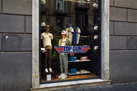 Naples, Italy - June 03 2022: Top Gun Maverick movie t-shirt clothing with logo at exterior window showcase of Alcott stores.のeditorial素材