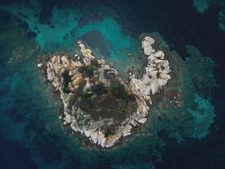 Drone view above small rocky island with green vegetation in the Mediterranean at Chalkidiki peninsula, Greeceの写真素材