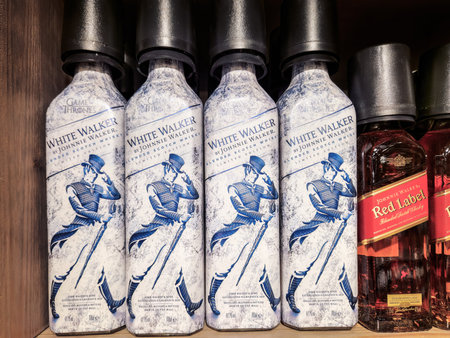Thessaloniki, Greece - December 28 2022: Johnnie Walker White blended Scotch Whisky bottle. Limited edition Game Of Thrones alcoholic drinks with logo on a liquor store display.のeditorial素材