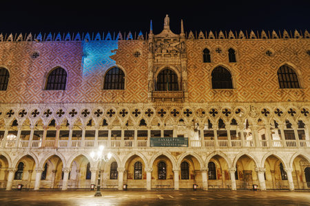 Venice Italy - February 23 2019: night view of illuminated Palazzo Ducale landmark, 1340 Doges Palace built in Venetian Gothic style at St. Marks square.のeditorial素材