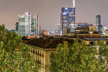 Milan, Italy May 13 2018: skyline night view of illuminated skyscrapers at Gae Aulenti Square in the wider Porta Nuova area with UniCredit Tower, tallest building in Italy visible at 231 meters high.のeditorial素材
