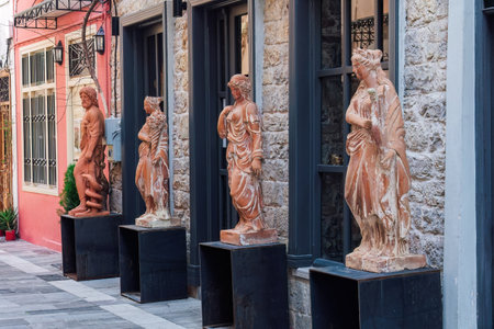Ancient Greek full-size statue replicas outside a shop facade in Nafplio, Greece.のeditorial素材