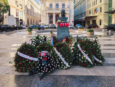Bucharest Romania - October 31 2023: Mustafa Kemal Ataturk bust statue with Turkish flags and flower wreaths at a central square.のeditorial素材